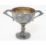 An Art Deco silver trophy cup of pedestal form with twin handles, hallmarked London 1936,