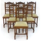 A set of six 20thC oak dining chairs with carved cresting rails and turned supports to the