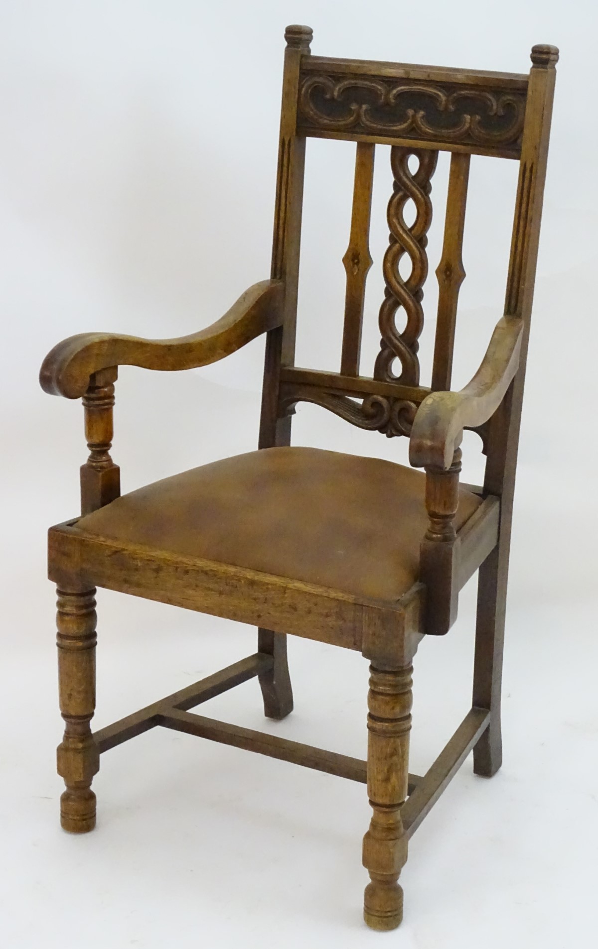 An early 20thC oak open armchair with a Celtic style carved top rail and back ress, - Image 6 of 8