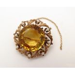 A 9ct gold brooch set with central facet cut citrine,