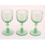 Three green glass pedestal wine glasses with engraved armorial depicting a bull and titled with