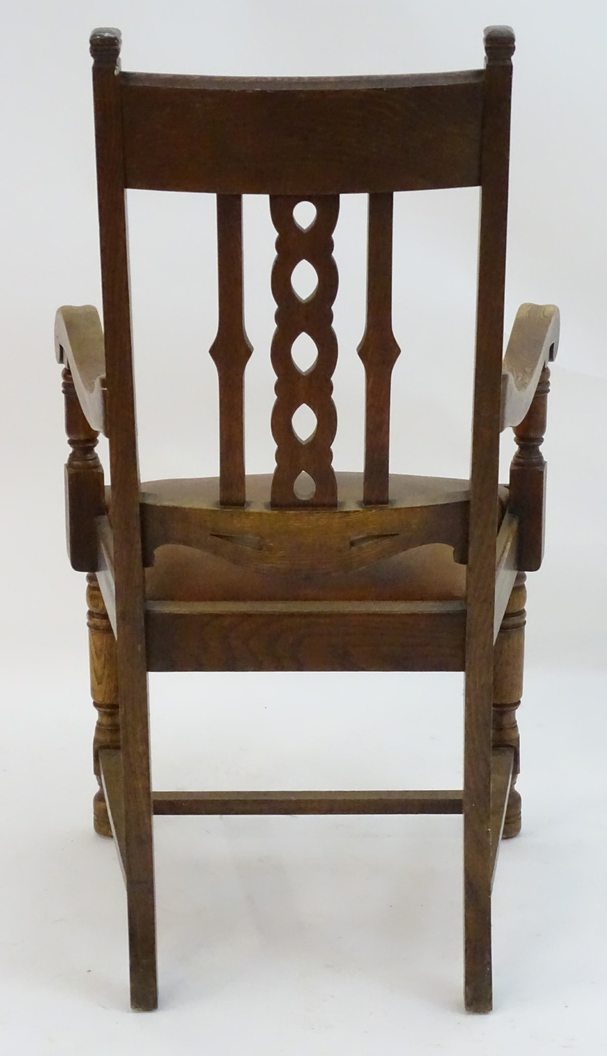 An early 20thC oak open armchair with a Celtic style carved top rail and back ress, - Image 8 of 8