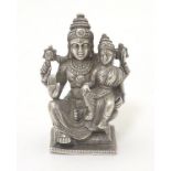 A white metal miniature model of a seated deity with child. Probably Indian 1 3/4'' high