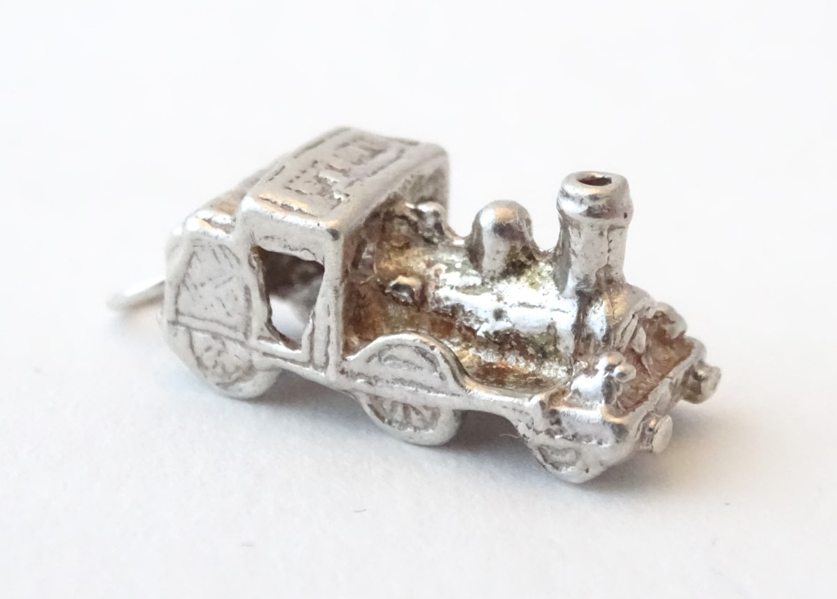 A novelty silver pendant charm formed as a steam train. Approx. 3/4" long.