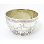 A Victorian silver bowl with engraved and punch work decoration.