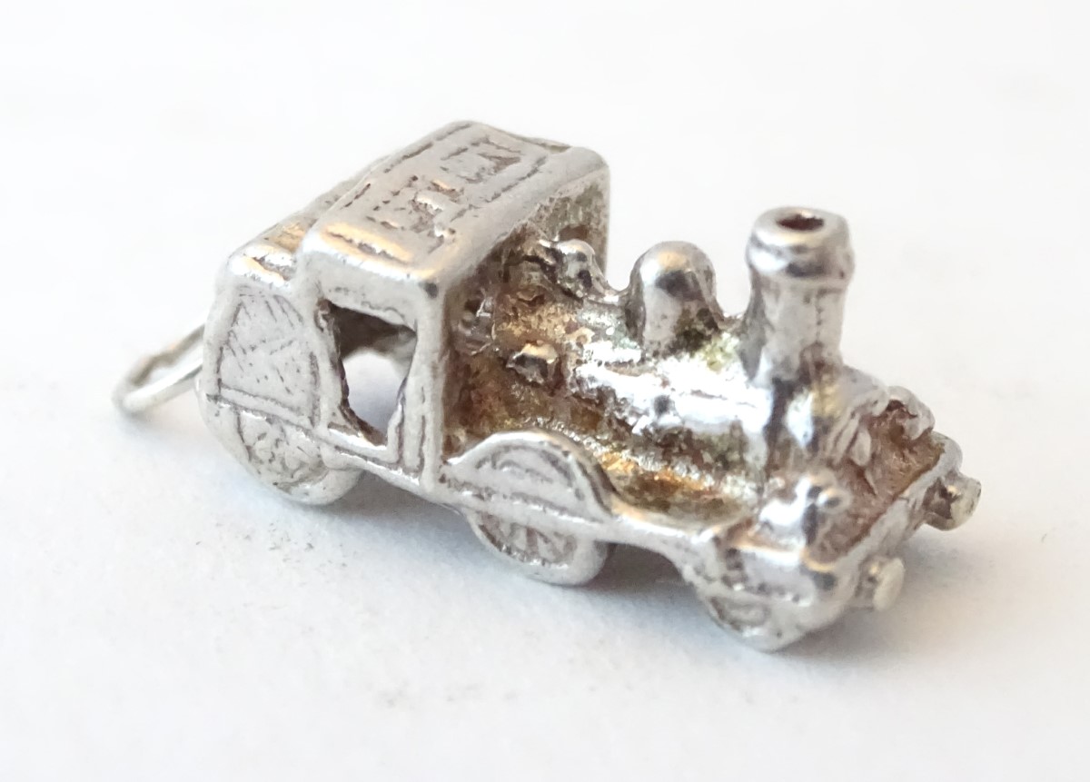 A novelty silver pendant charm formed as a steam train. Approx. 3/4" long. - Image 2 of 6