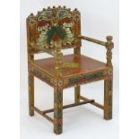 A 20thC painted open armchair with a carved frame, applied beadwork and painted decoration,