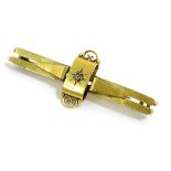 A gold bar brooch set with central diamond,