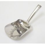 A silver caddy spoon of shovel form. Hallmarked Birmingham 1802 maker IT.