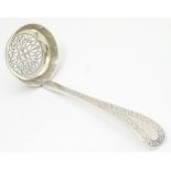 A silver sifter spoon / ladle with bright cut and pierced decoration.