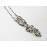 A silver necklace with pendant set with marcasite detail.