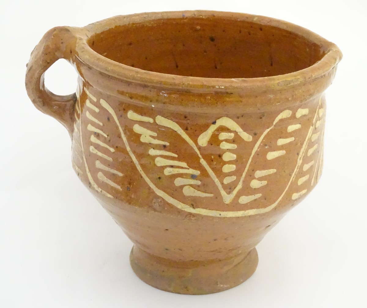 An 18th / 19thC French jug / vessel with a side handle and narrow base, with slipware decoration. - Image 3 of 8