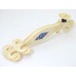 A late 19thC carved marine ivory pastry crimper with five wheels,