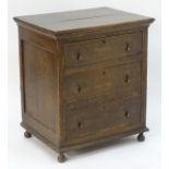An 18thC oak chest with a moulded top above three long drawers with drop handles and the chest
