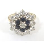 A 9ct gold dress ring set with blue and white paste stones. Ring size approx.