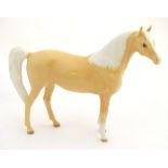 A Royal Doulton palomino horse, model number DA 55. Marked under. Approx. 6 1/2" high.