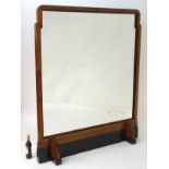 A large mid 20thC Art Deco mirror with a walnut and ebonised frame.