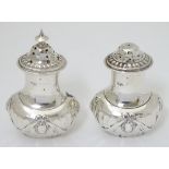 A pair of silver salt and pepper pots Hallmarked Birmingham 1900 maker Mappin & Webb Ltd.