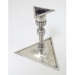 A continental silver candlestick on a triangular base. Probably French maker VJ.