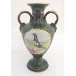 A 20thC baluster vase with a bulbous body, flared foot and rim and twin loop handles.