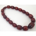 A vintage necklace of red cherry amber coloured graduated beads.