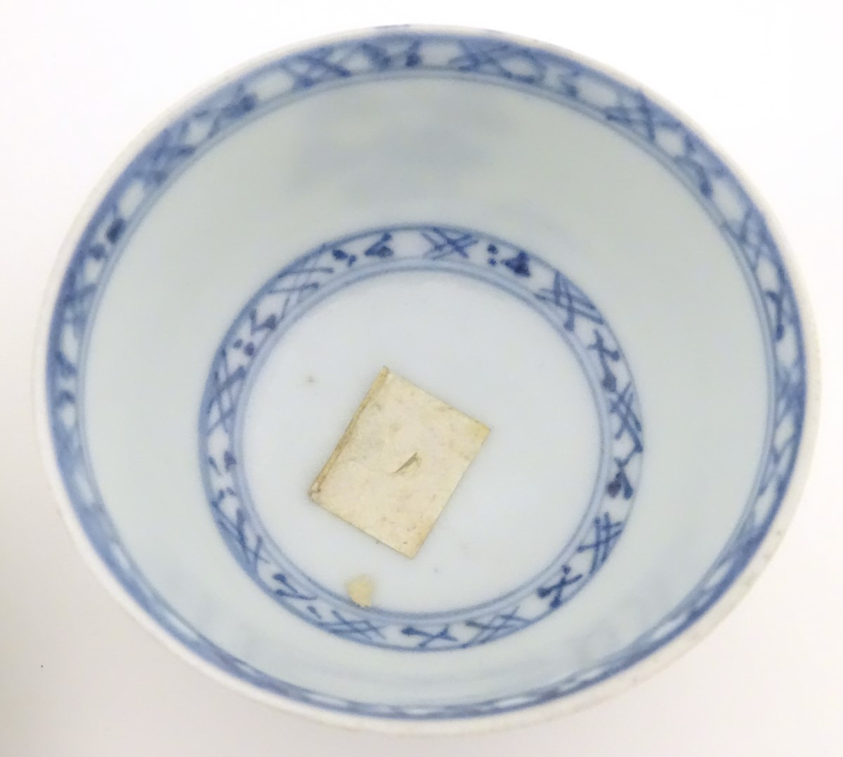 An 18thC Chinese Nanking Cargo blue and white tea bowl and saucer, decorated with pine trees. - Image 7 of 10