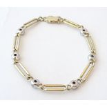 A 14ct gold bracelet having 6 diamonds set in white gold. Approx. 7" long.