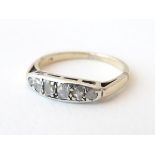 A 14ct gold ring set with 6 graduated diamonds to top in a setting approx. 3/4" wide.