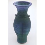 A 20thC studio pottery barium glaze vase by Simon Shaw, with a bulbous body and a flared rim,