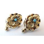 An ornate pair of 14ct gold drop earrings of stylised floral form set with central turquoise.