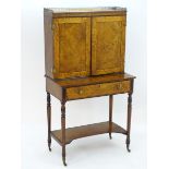 A Regency bonheur du jour with a brass gallery above a crossbanded top and two marquetry decorated