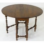 A mid 18thC oak gateleg table opening to form an oval top,