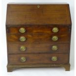 A late 18thC mahogany bureau with a fall front containing pigeon holes and fitted drawers within,