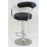 A late 20thC adjustable swivel seat with an upholstered curved backrest and rounded seat,