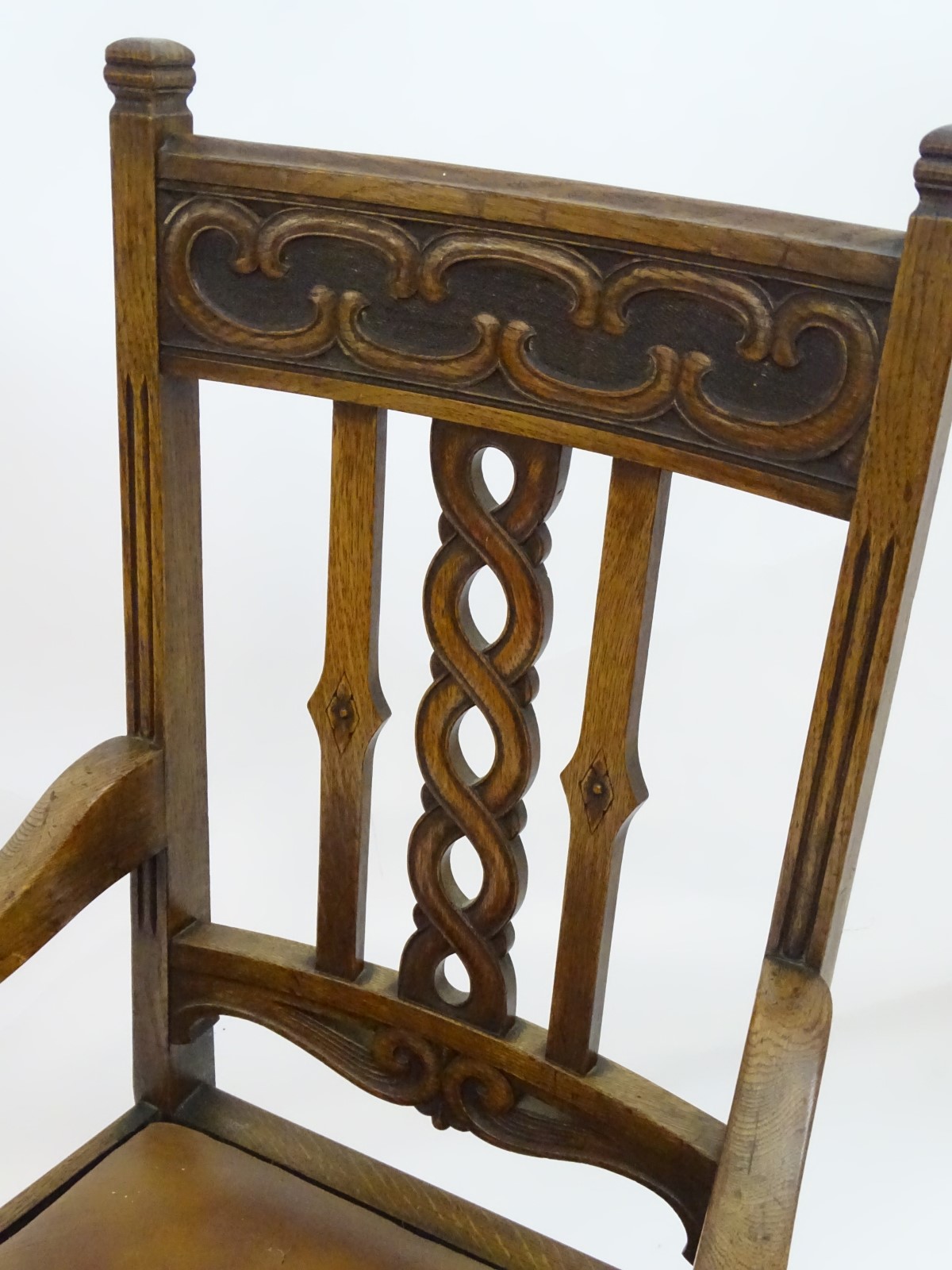 An early 20thC oak open armchair with a Celtic style carved top rail and back ress, - Image 7 of 8