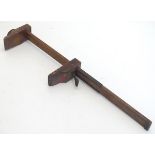 A 19th / 20thC wooden foot rule / shoe gauge,