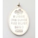 A silver pendant with rose decoration. Titled 'Suisse One ounce Fine Silver 999.