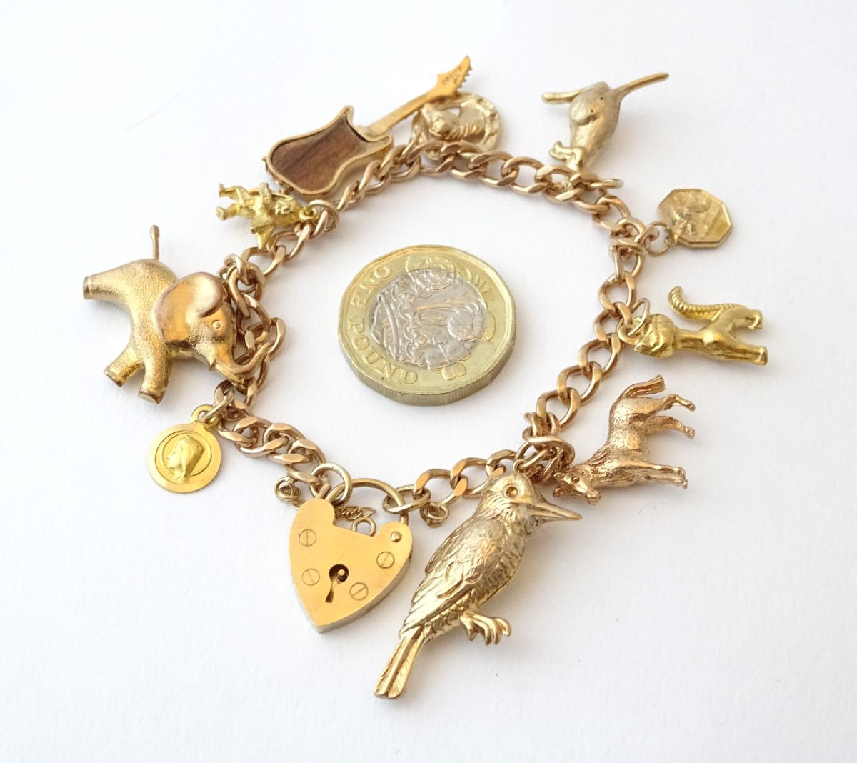 A 9ct gold charm bracelet set with various 9ct and yellow metal etc charms. - Image 2 of 7