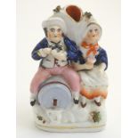 A Victorian Staffordshire pottery flatback spill vase depicting a man and a woman,