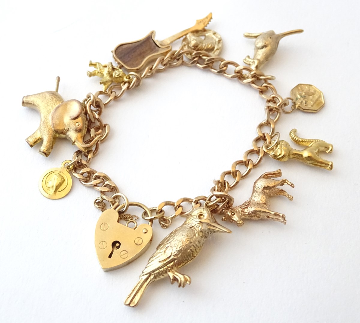 A 9ct gold charm bracelet set with various 9ct and yellow metal etc charms. - Image 3 of 7