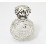 A cut glass scent bottle with silver top hallmarked Birmingham 1907 maker J H Worrall, Son & Co.