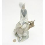 A Lladro 'New Shepherdess' figurine of a girl sat watching a bird, makers mark to base,