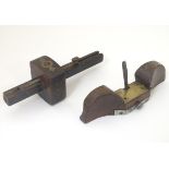 Two early 20thC carpentry tools, a marker gauge and spoke shave,