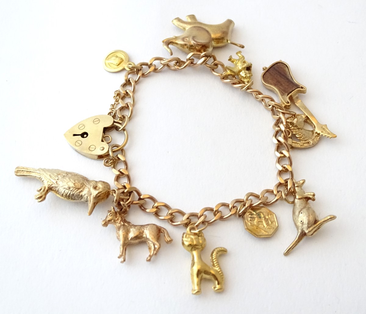 A 9ct gold charm bracelet set with various 9ct and yellow metal etc charms. - Image 4 of 7