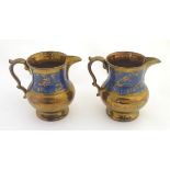 A pair of Victorian copper lustre ware jugs with banded cobalt foliate decoration. Approx.