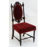 A late 19thC rosewood chair with a carved cresting rail above barley twist turned supports and