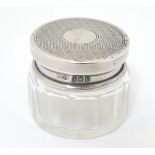 A small glass pot with silver top, hallmarked Birmingham 1927, maker JMC. Approx.