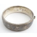A silver bracelet of bangle form hallmarked Birmingham 1988 maker Herbert Bushell & Son Ltd.