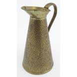 A brass jug / pitcher with hammered decoration by Joseph Sankey & Son. Marked under. 11" high Please