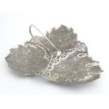 A white metal trip form dish of leaf form. probably Indian. 9 3/4" long Please Note - we do not make